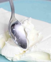 Checking whether cream cheese is softened using the back of a spoon