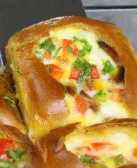 Lifting homemade Breakfast Sliders out of the baking pan