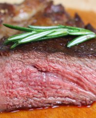 Cross-sectional view of a chuck eye steak cooked medium and showing a pale pink color