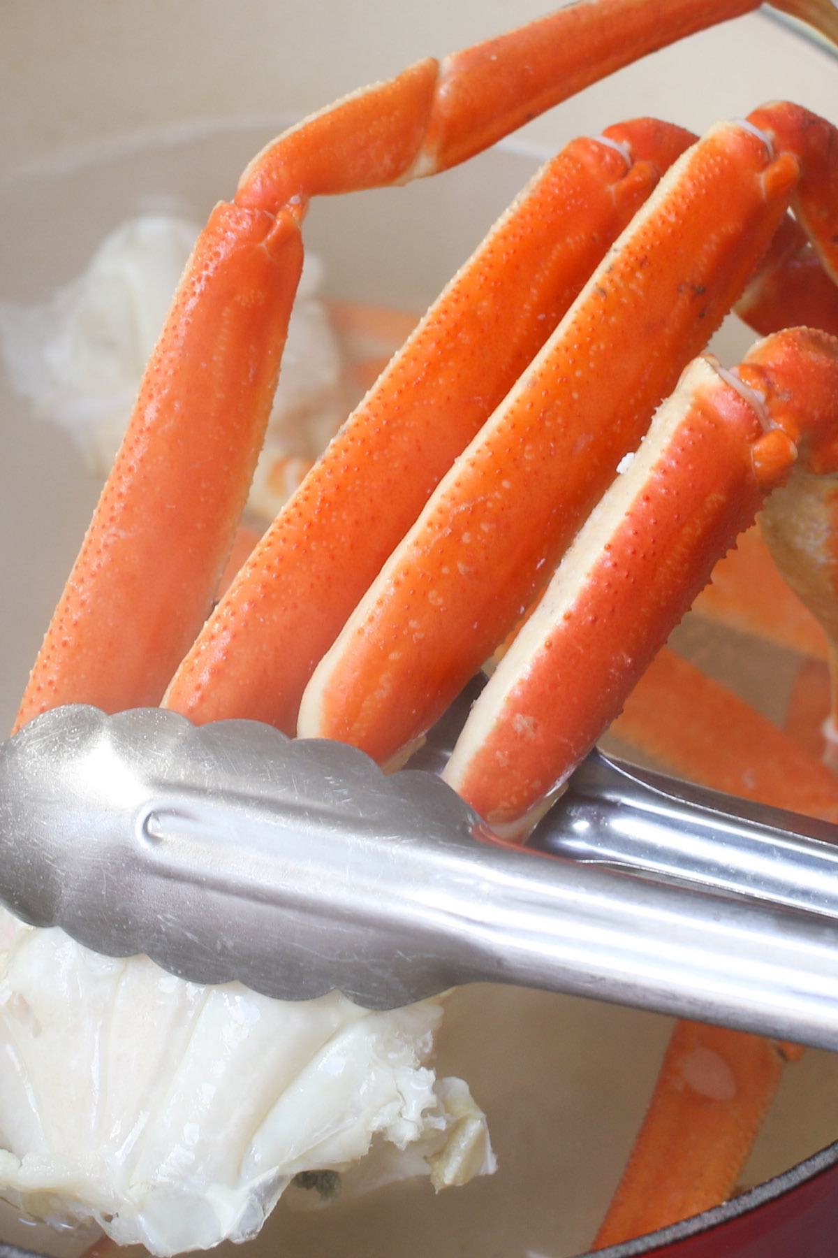 Boiling crab legs in a large pot.