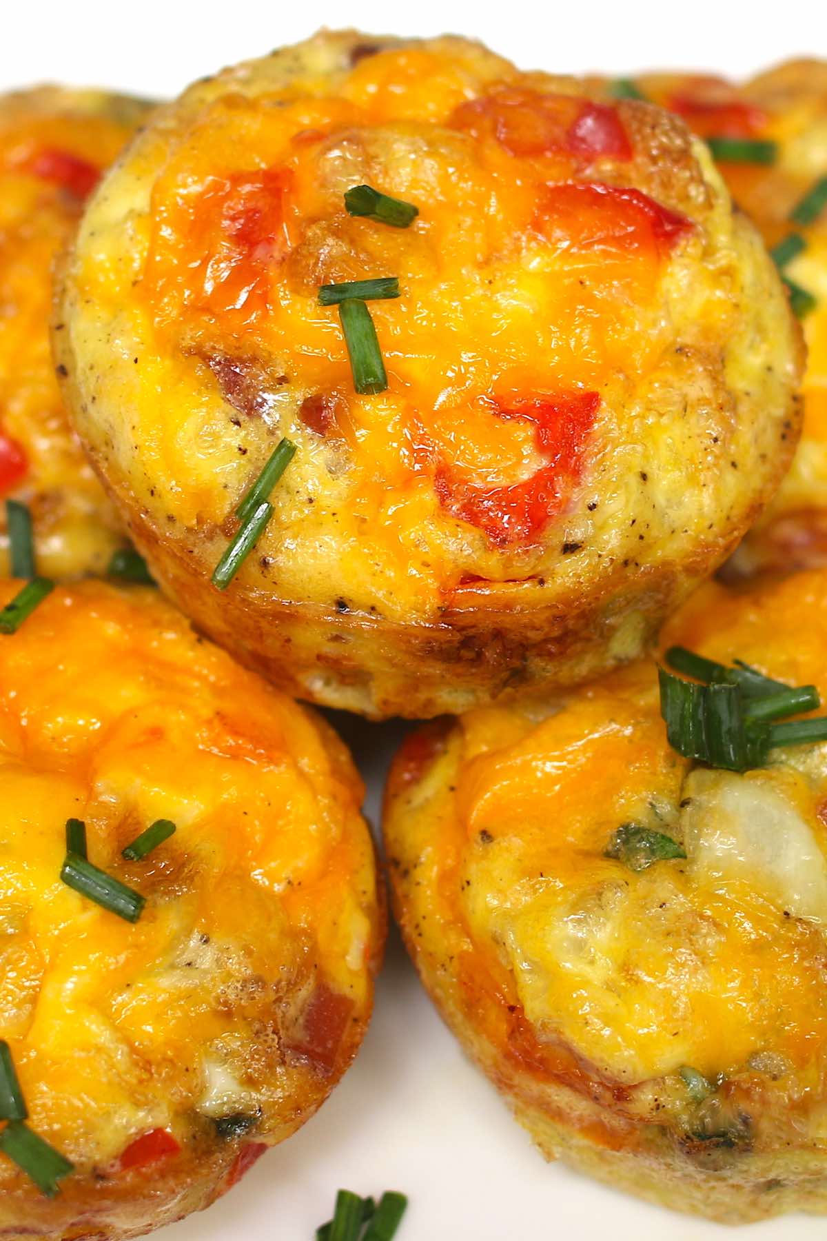 These freezer-friendly Egg Muffins are made with eggs, cheese, bacon, spinach, onions, and bell peppers. An easy make-ahead recipe, they only take a few minutes to throw together. These breakfast muffins are delicious, healthy and nutritious, perfect for busy mornings!