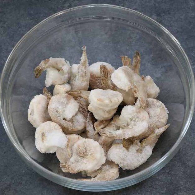 Frozen Shrimp in a mixing bowl ready for thawing