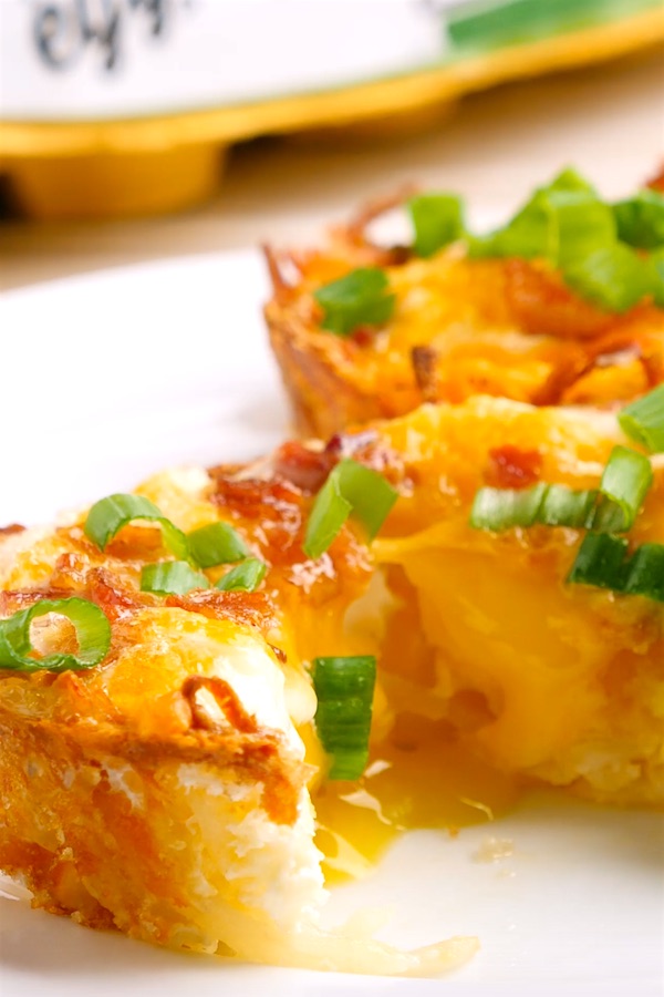 Closeup of a hash brown egg nest being cut open to be eaten