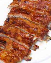 Perfectly cooked spare ribs with the bone sticking out a half-inch from the meat