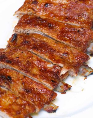 Perfectly cooked spare ribs with the bone sticking out a half-inch from the meat