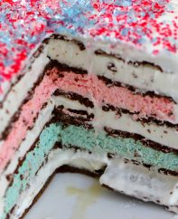 Closeup photo showing the layers of an ice cream sandwich cake with sprinkles on top