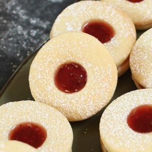 These soft and buttery homemade Jammie Dodgers are a UK staple! They are two shortbread biscuits sandwiched together with fruity jam such as strawberry or raspberry.