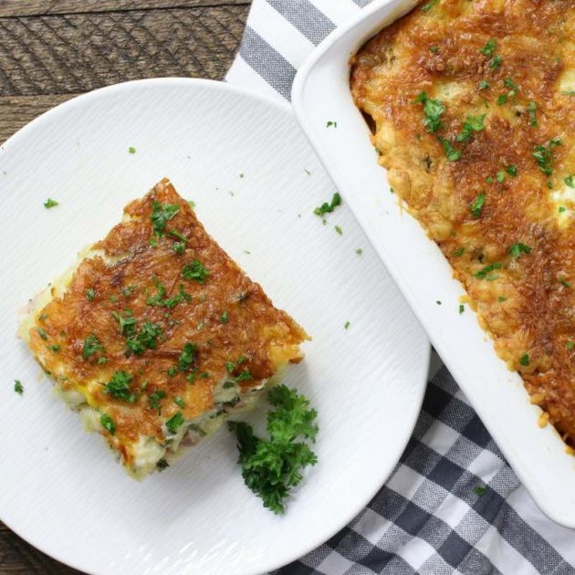 Serving of layered pasta bake showing the crispy au gratin 