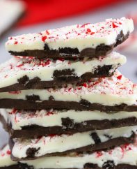 Closeup of peppermint chocolate bark showing the layers of chocolate, crushed oreos and candy cane on top