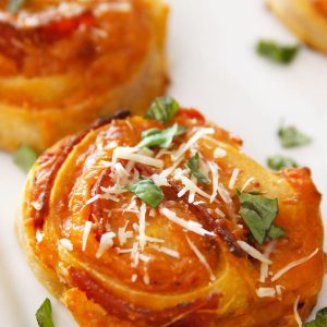 These Pizza Rolls are my favorite Italian appetizer that’s loaded with pepperoni and cheese rolled in pizza dough. Baked to perfection in the oven and you can serve these mini rolls with pizza sauce for the easy last-minute snack!