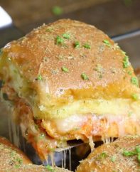 Closeup of pizza sliders fresh out of the oven with a cheese pull