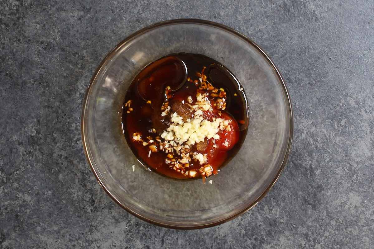 Showing how to make pork chop marinade. Mixing ingredients in a glass mixing bowl.