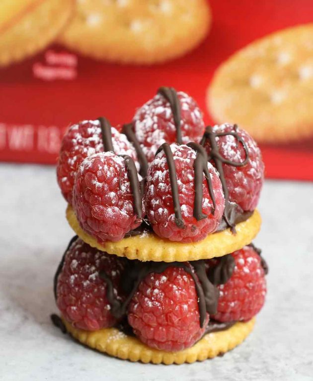 A double decker raspberry chocolate bite dusted with powdered sugar