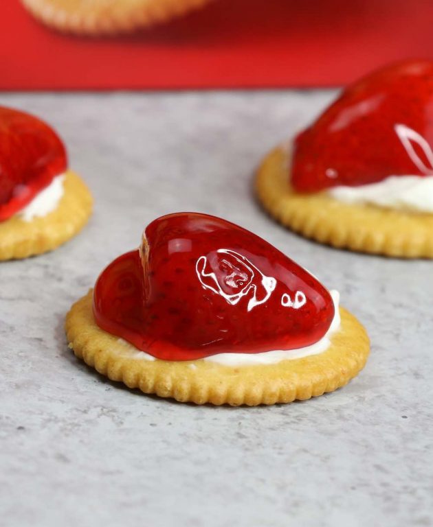 Strawberry cheesecake bites made with strawberry pie filling and cream cheese on a Ritz cracker