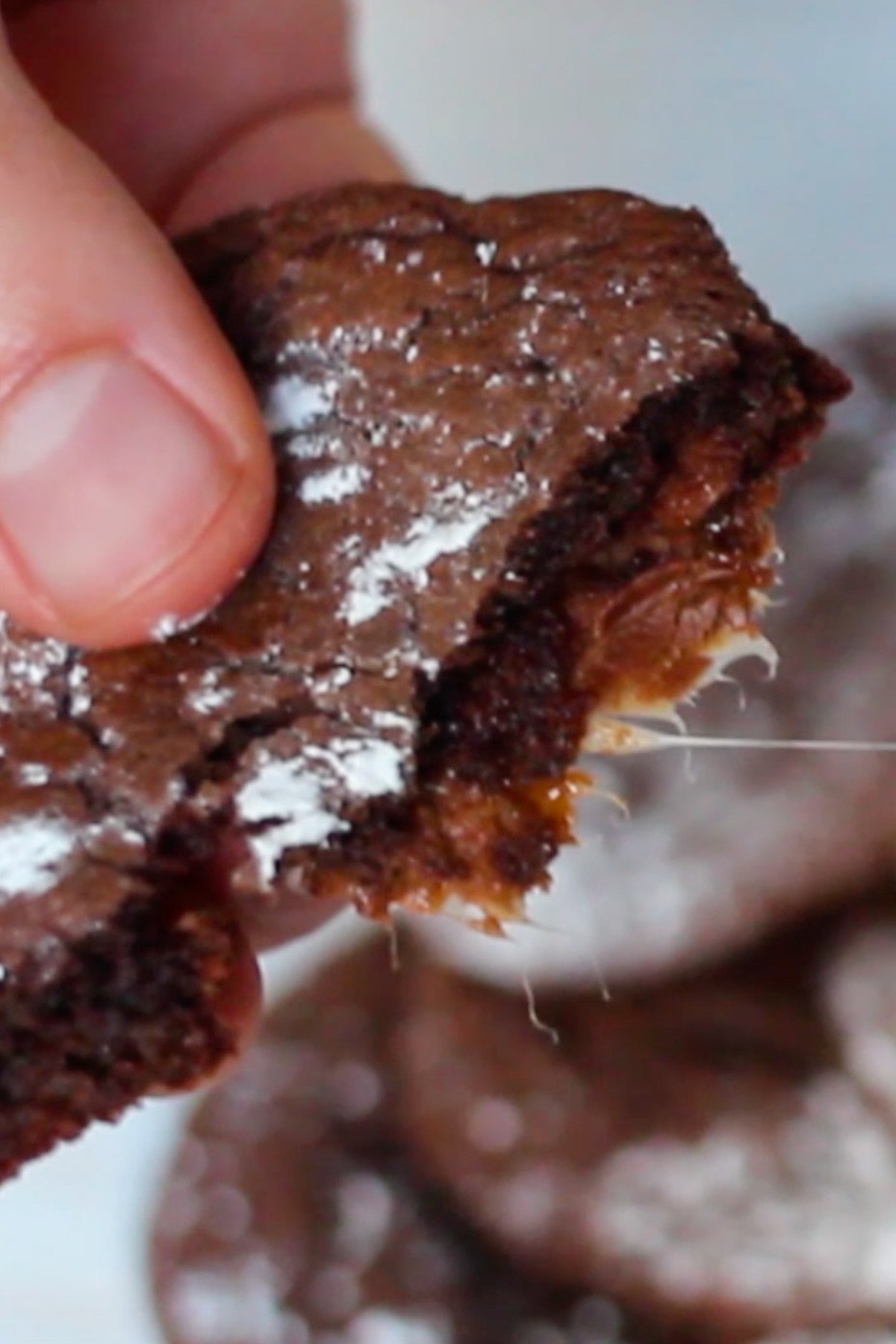 Rolo candy oozing out from a freshly cooked Rolo cookie.