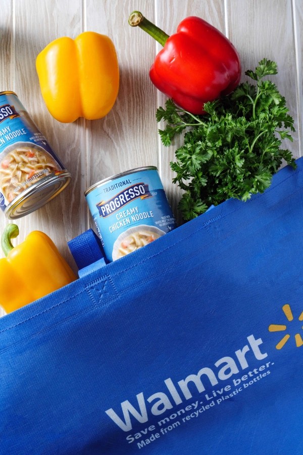 Shopping bag full of ingredients for making Stuffed Bell Peppers including Progresso Creamy Chicken Noodle Soup