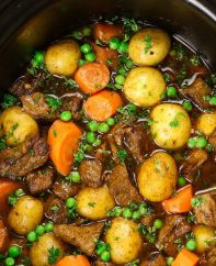 Slow Cooker Beef Stew is one of the best hearty and comfort food to make in a crock pot. Tender and melt-in-your-mouth beef is simmered in a rich and divine sauce with carrots, onions, and potatoes. Your family and friends will ask for this Crock Pot Beef Stew again and again! Plus recipe video tutorial!