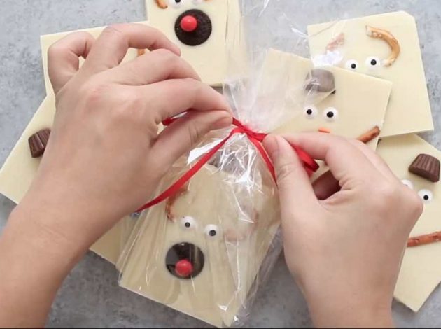 Wrapping up pieces of white chocolate bark into DIY holiday gifts for friends, family, teachers and neighbors