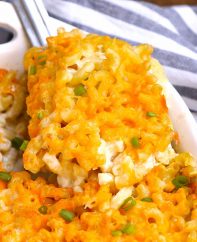 Lifting a serving of Southern Mac and Cheese out of the baking dish