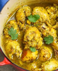 Trinidad curry chicken in a pot garnished with cilantro