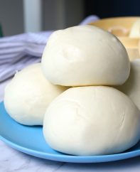 Freshly made steamed buns stacked on a serving plate ready to eat