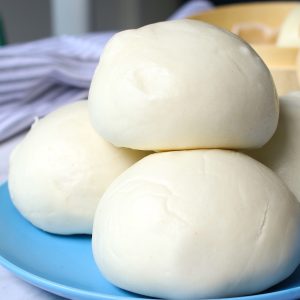 Freshly made steamed buns stacked on a serving plate ready to eat