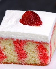 Strawberry Jello Poke Cake is a traditional southern dessert featuring a cake layer imbued with strawberry jello, a creamy topping and fresh strawberries on top