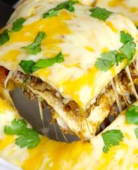 A cheesy Taco Casserole being being served out of a baking dish