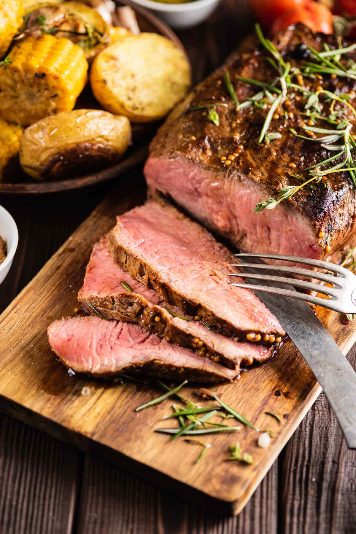 Slices of top round roast beef on a carving board
